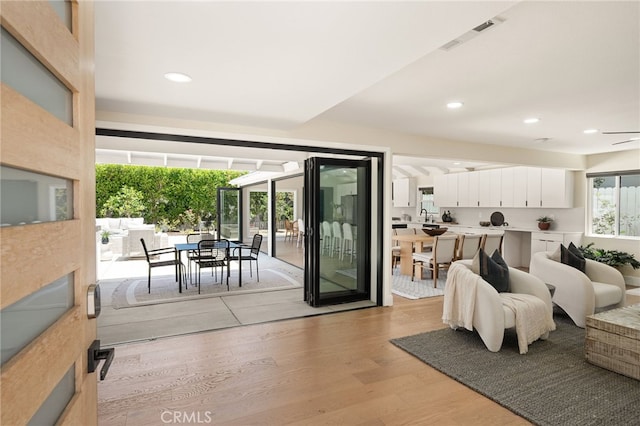 1700 Irvine Ave, Newport Beach, CA 92660 - living area with light wood-type flooring, recessed lighting, and a ceiling fan