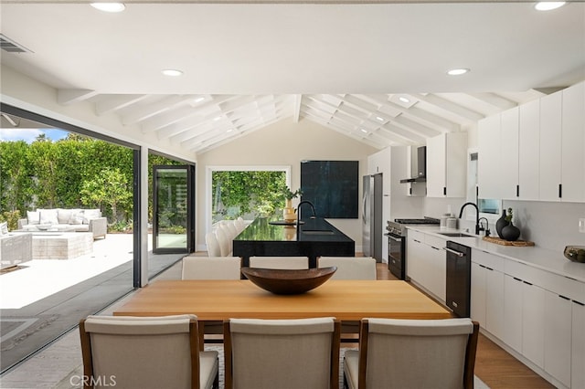 1700 Irvine Ave, Newport Beach, CA 92660 - kitchen with appliances with stainless steel finishes, white cabinetry, light wood finished floors, an island with sink, and light countertops