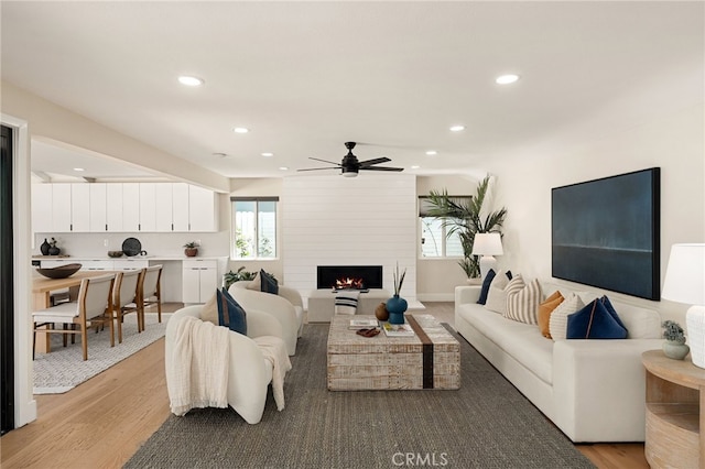 1700 Irvine Ave, Newport Beach, CA 92660 - living area with recessed lighting, plenty of natural light, light wood-type flooring, a fireplace, and a ceiling fan