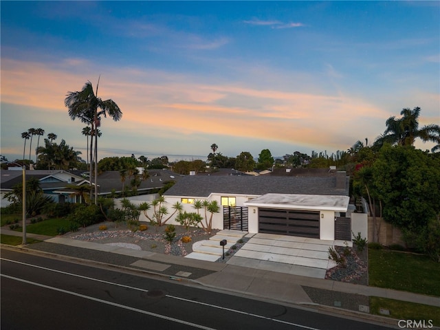 1700 Irvine Ave, Newport Beach, CA 92660 - modern home with driveway, an attached garage, a gate, and stucco siding