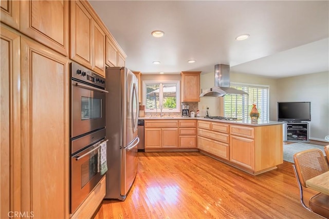 2526 Fontezuela Dr, Hacienda Heights, CA 91745 - kitchen with light brown cabinets, wall chimney exhaust hood, appliances with stainless steel finishes, light wood-style flooring, and open floor plan
