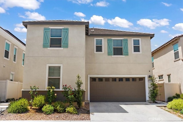 955 W Jasmine Way, Rialto, CA 92376 - view of front of home featuring driveway, stucco siding, and an attached garage