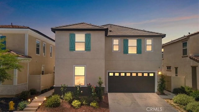 955 W Jasmine Way, Rialto, CA 92376 - view of front facade featuring driveway, a garage, stucco siding, and a tile roof