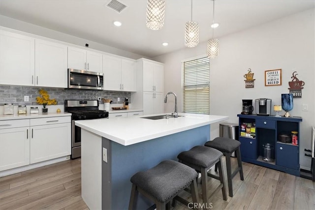 955 W Jasmine Way, Rialto, CA 92376 - kitchen featuring appliances with stainless steel finishes, backsplash, light wood-type flooring, a breakfast bar area, and recessed lighting