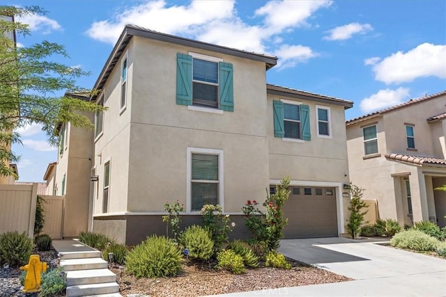 955 W Jasmine Way, Rialto, CA 92376 - view of front of house featuring driveway, an attached garage, and stucco siding