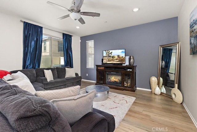 955 W Jasmine Way, Rialto, CA 92376 - living area with wood finished floors, ceiling fan, recessed lighting, and a glass covered fireplace