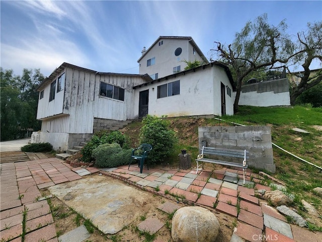 11860 W Trail Trail, Sylmar, CA 91342 - rear view of house featuring board and batten siding and a patio