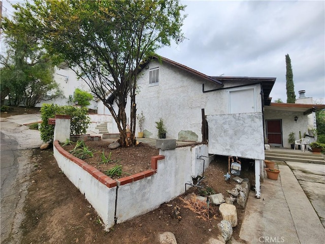 11860 W Trail Trail, Sylmar, CA 91342 - view of side of property with stucco siding and a chimney