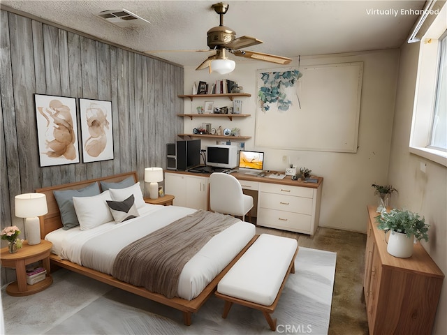 11860 W Trail Trail, Sylmar, CA 91342 - bedroom featuring built in desk, wooden walls, light carpet, and ceiling fan