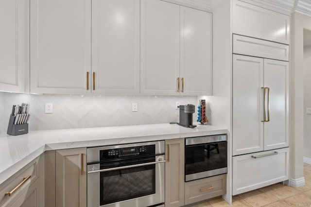 13502 Blue Lace Trl, Carmel Valley, CA 92130 - kitchen with stainless steel microwave, light stone countertops, white cabinets, and backsplash