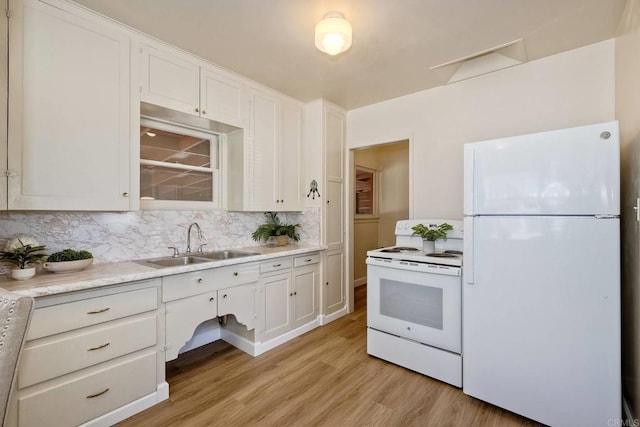 4693 71st St, La Mesa, CA 91942 - kitchen with white appliances, light wood-style flooring, backsplash, light countertops, and white cabinets
