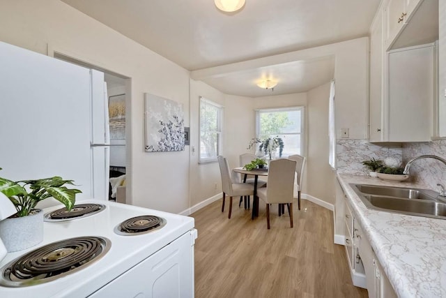 4693 71st St, La Mesa, CA 91942 - kitchen with white appliances, light countertops, light wood-type flooring, and white cabinetry