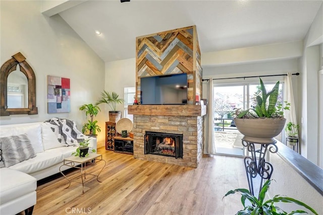 25072 Leucadia St Unit E, Laguna Niguel, CA 92677 - living room with wood finished floors, a fireplace, and high vaulted ceiling