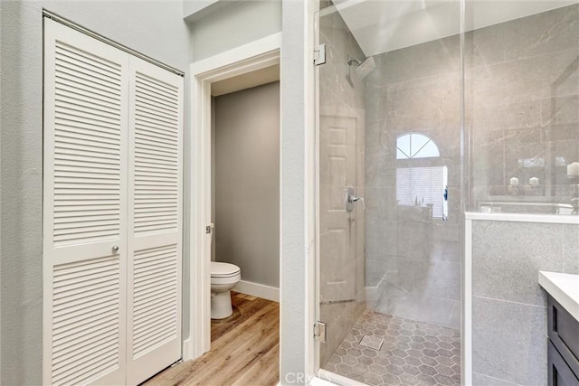 25072 Leucadia St Unit E, Laguna Niguel, CA 92677 - full bathroom with a stall shower, a closet, vanity, and wood finished floors