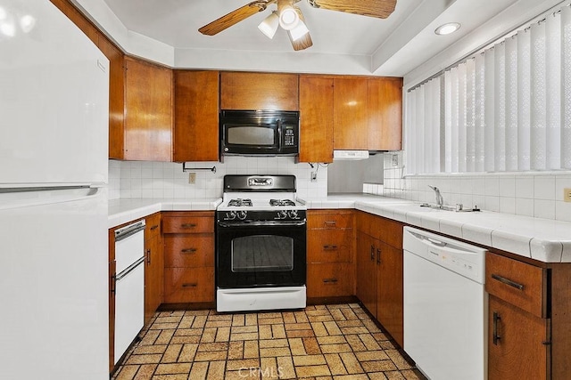3431 Caspian Ave, Long Beach, CA 90810 - kitchen featuring black appliances, brown cabinetry, brick patterned floors, and backsplash