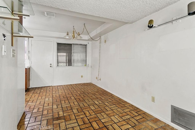 3431 Caspian Ave, Long Beach, CA 90810 - empty room with brick patterned flooring and a textured ceiling