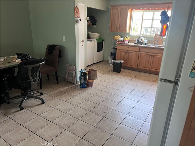 1222 E 103rd St, Los Angeles, CA 90002 - kitchen with freestanding refrigerator, washing machine and clothes dryer, light tile patterned floors, and light countertops