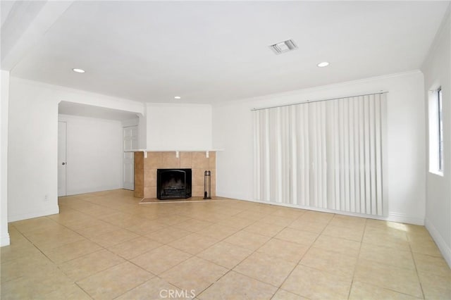 19324 Victory Blvd, Reseda, CA 91335 - unfurnished living room featuring crown molding, a tiled fireplace, recessed lighting, and light tile patterned flooring