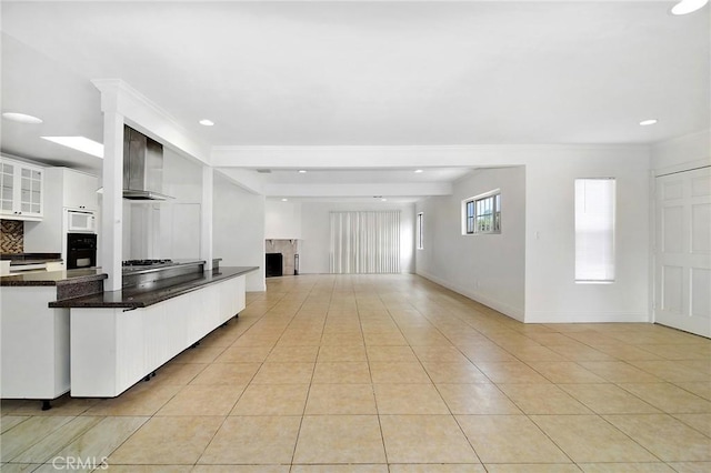 19324 Victory Blvd, Reseda, CA 91335 - kitchen featuring white microwave, oven, light tile patterned flooring, a high end fireplace, and white cabinets
