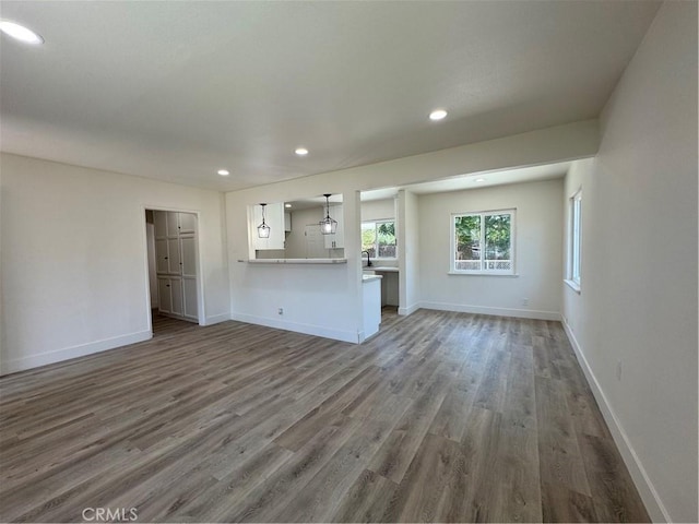 10615 Wolfe Ave, Riverside, CA 92505 - unfurnished living room with wood finished floors and recessed lighting