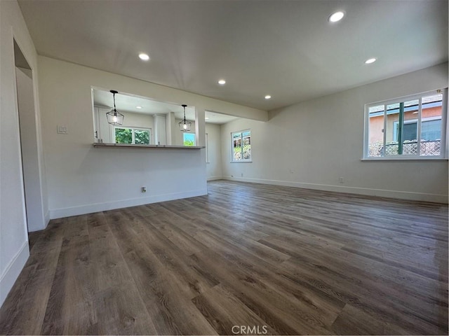 10615 Wolfe Ave, Riverside, CA 92505 - unfurnished living room with dark wood-style floors and recessed lighting