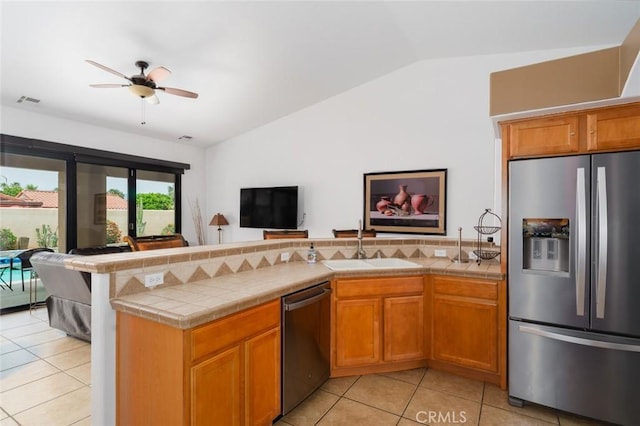79140 Fred Waring Dr, Bermuda Dunes, CA 92203 - kitchen with stainless steel appliances, open floor plan, lofted ceiling, light tile patterned floors, and a peninsula