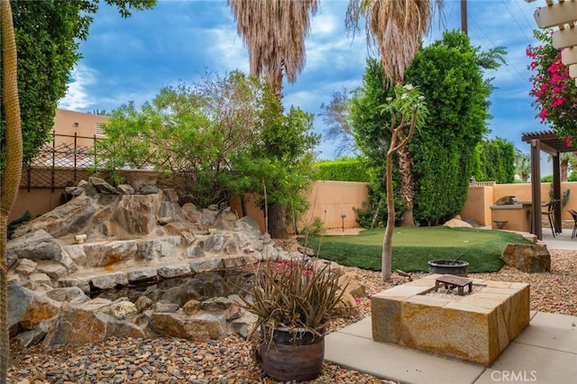 79140 Fred Waring Dr, Bermuda Dunes, CA 92203 - fenced backyard with a fire pit and a patio area