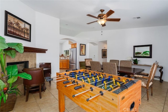 79140 Fred Waring Dr, Bermuda Dunes, CA 92203 - recreation room with vaulted ceiling, light tile patterned floors, arched walkways, a ceiling fan, and a fireplace