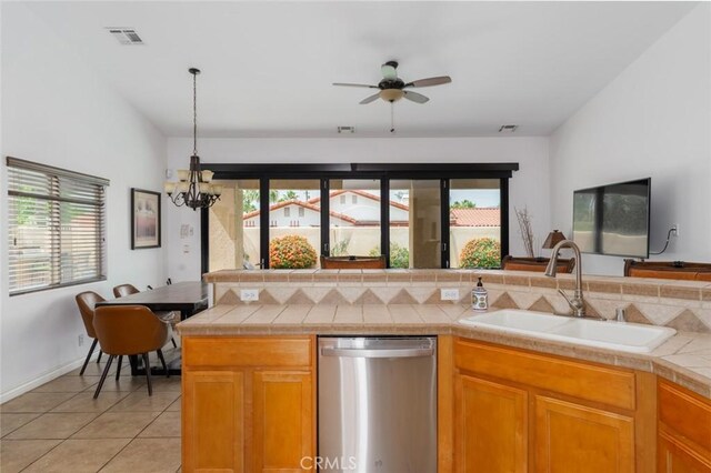 79140 Fred Waring Dr, Bermuda Dunes, CA 92203 - kitchen featuring stainless steel dishwasher, ceiling fan, a chandelier, light tile patterned floors, and tile countertops