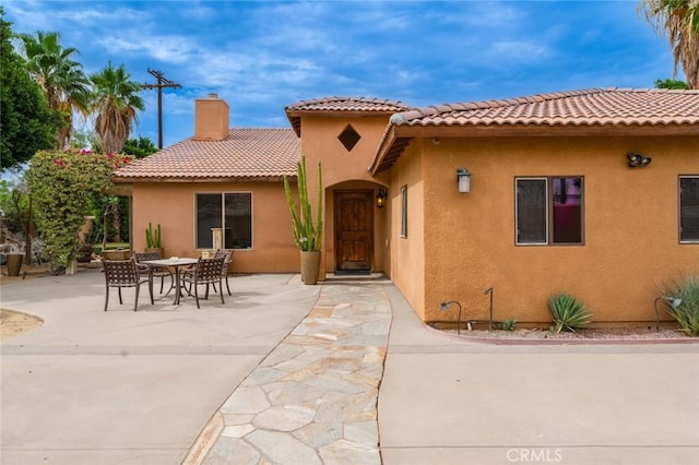 79140 Fred Waring Dr, Bermuda Dunes, CA 92203 - rear view of property featuring stucco siding, a chimney, a patio, and a tile roof