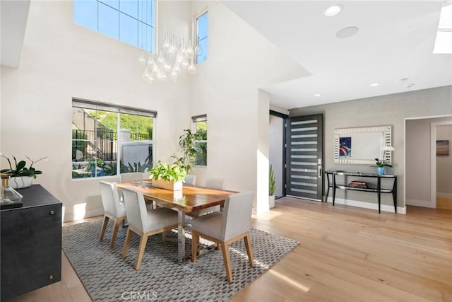 8 Pavona, Newport Coast, CA 92657 - dining space with wood finished floors, a chandelier, recessed lighting, and a towering ceiling