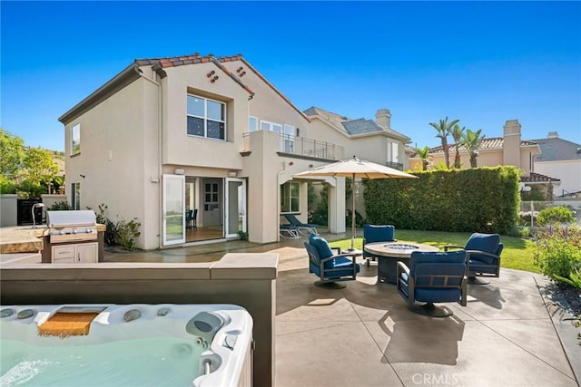 8 Pavona, Newport Coast, CA 92657 - patio / terrace with an outdoor fire pit, a patio, a hot tub, and an outdoor kitchen