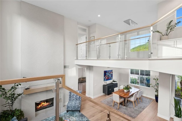 8 Pavona, Newport Coast, CA 92657 - living area with light wood-style flooring, a tile fireplace, plenty of natural light, recessed lighting, and a towering ceiling