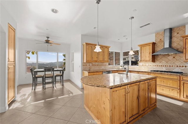 2240 Aqua Hill Rd, Fallbrook, CA 92028 - kitchen featuring wall chimney exhaust hood, a kitchen island with sink, stainless steel appliances, a ceiling fan, and decorative backsplash