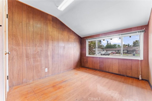 1305 S Westchester Dr, Anaheim, CA 92804 - spare room featuring wood finished floors, lofted ceiling, and wooden walls