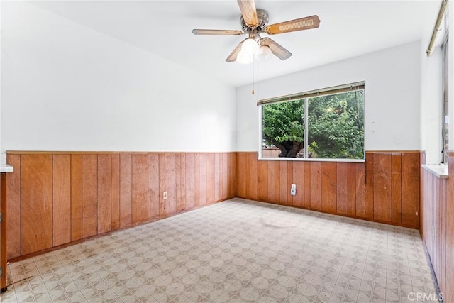 1305 S Westchester Dr, Anaheim, CA 92804 - unfurnished room featuring a wainscoted wall, tile patterned floors, wood walls, and a ceiling fan