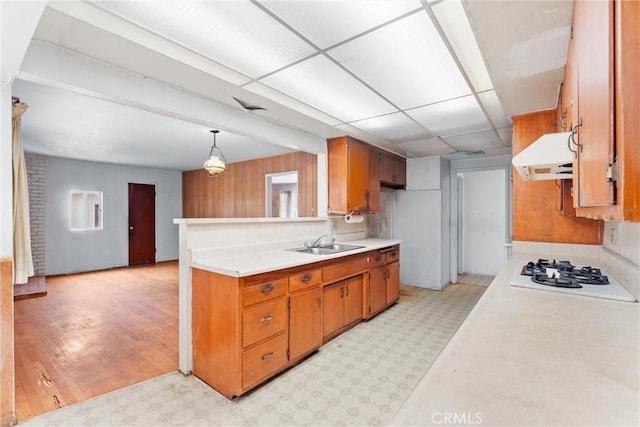 1305 S Westchester Dr, Anaheim, CA 92804 - kitchen with extractor fan, white gas stovetop, light countertops, light flooring, and brown cabinetry