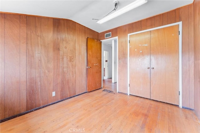 1305 S Westchester Dr, Anaheim, CA 92804 - unfurnished bedroom featuring wood finished floors, wooden walls, lofted ceiling, and a closet