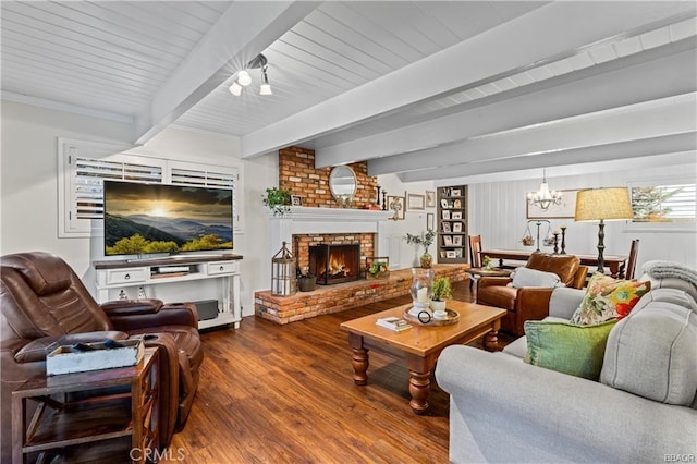235 Bret Harte Rd, Lake Arrowhead, CA 92352 - living room featuring wood finished floors, a chandelier, beamed ceiling, and a brick fireplace