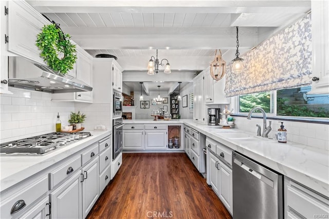 235 Bret Harte Rd, Lake Arrowhead, CA 92352 - kitchen with stainless steel appliances, range hood, a chandelier, dark wood finished floors, and white cabinetry