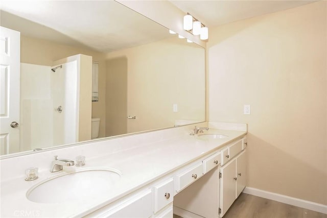 44930 11th St E, Lancaster, CA 93535 - full bath featuring double vanity, wood finished floors, and a shower
