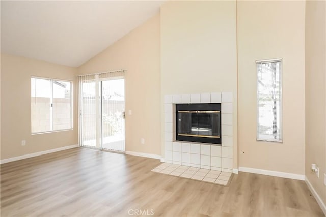 44930 11th St E, Lancaster, CA 93535 - unfurnished living room featuring light wood-style floors, a fireplace, and high vaulted ceiling