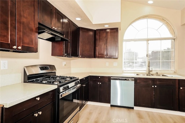 44930 11th St E, Lancaster, CA 93535 - kitchen featuring appliances with stainless steel finishes, under cabinet range hood, light countertops, light wood-style floors, and recessed lighting