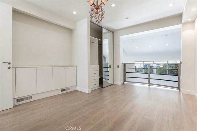 13331 Moorpark St Unit 319, Sherman Oaks, CA 91423 - spare room featuring light wood finished floors, a chandelier, and recessed lighting