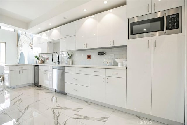 13331 Moorpark St Unit 319, Sherman Oaks, CA 91423 - kitchen with appliances with stainless steel finishes, light countertops, white cabinetry, decorative backsplash, and recessed lighting