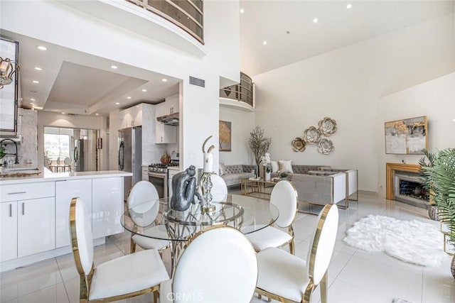 13331 Moorpark St Unit 319, Sherman Oaks, CA 91423 - dining space featuring recessed lighting, light tile patterned floors, and a high ceiling