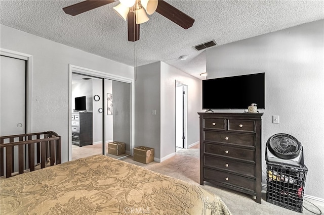 4883 E Geary St, Fresno, CA 93725 - carpeted bedroom featuring a textured ceiling, ceiling fan, and two closets