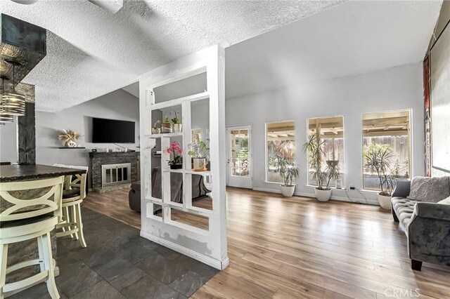 4883 E Geary St, Fresno, CA 93725 - living area with wood finished floors, a textured ceiling, and lofted ceiling