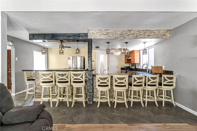 4883 E Geary St, Fresno, CA 93725 - dining room featuring bar and a textured ceiling