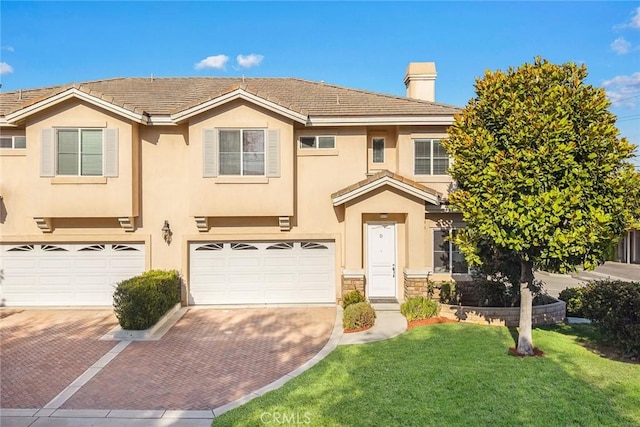 800 W Huntington Dr Unit D, Arcadia, CA 91007 - view of front facade featuring decorative driveway, a front lawn, stucco siding, a chimney, and a garage